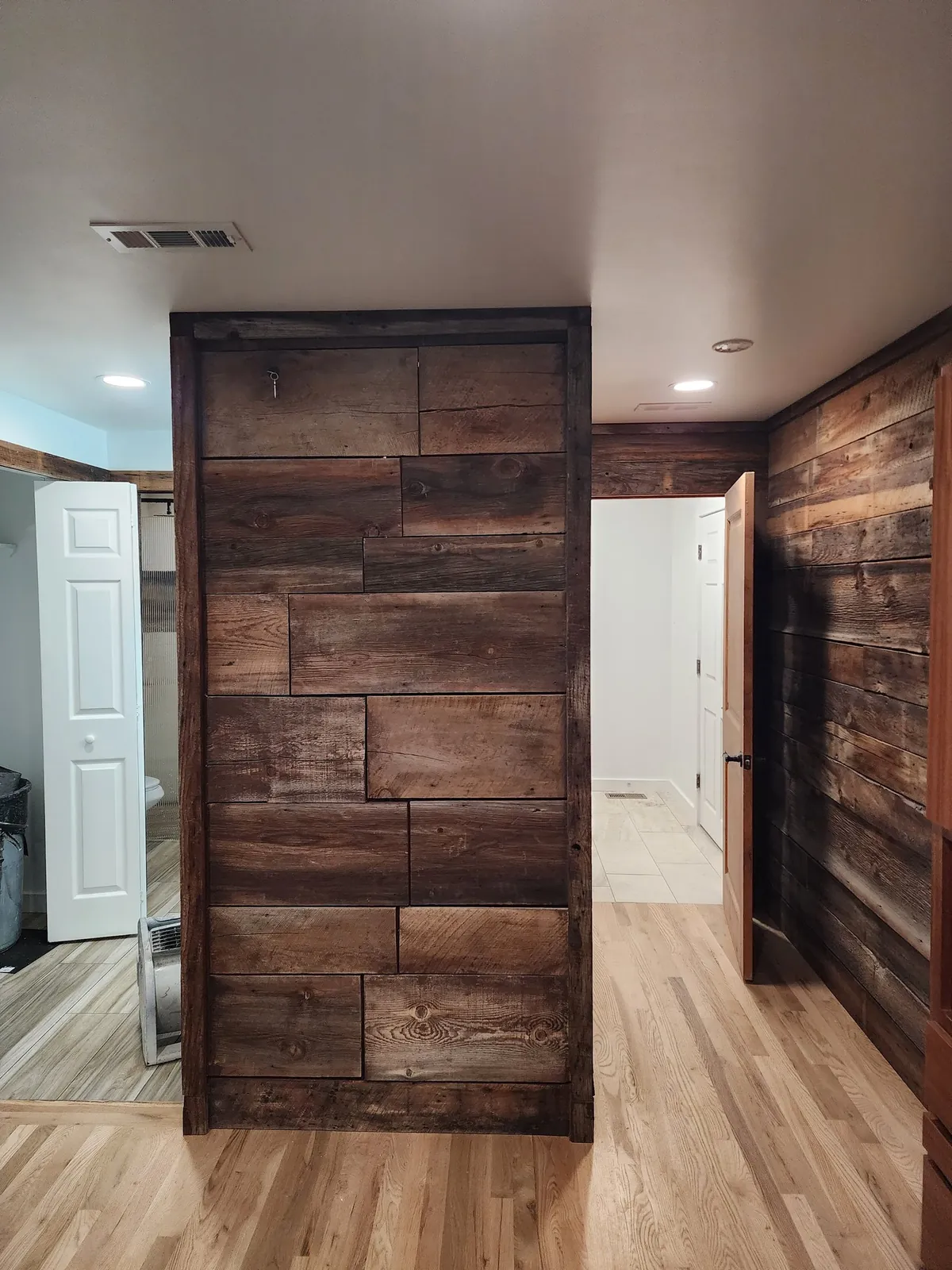 Barnwood feature wall and sliding doors by Keystone General Contractors